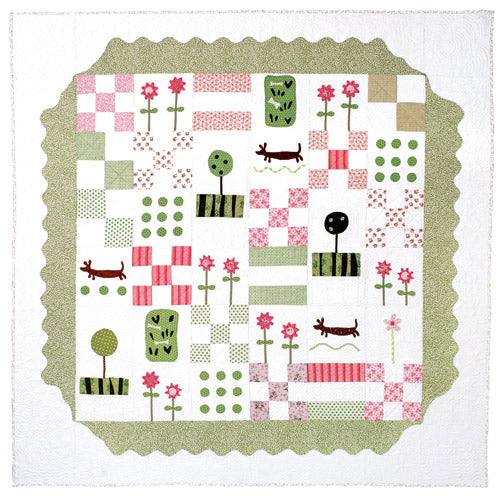 Flat shot of appliqué dachshund and flower patchwork quilt