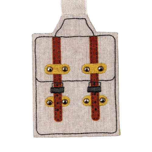 Flat shot of simple style luggage with straps on natural linen