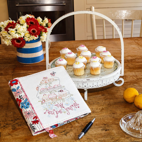 Styled shot of embroidered recipe journal in kitchen