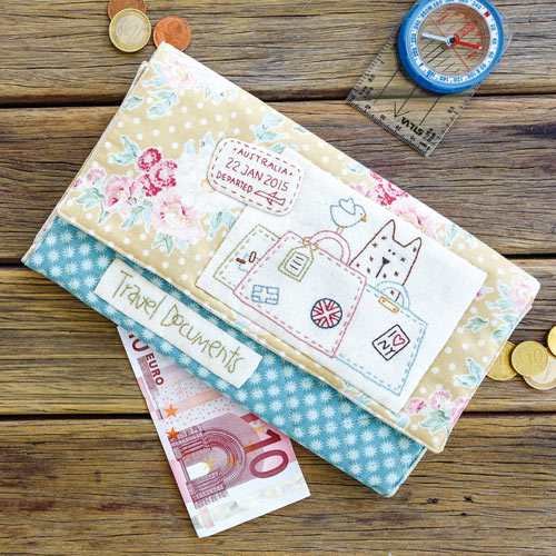 Styled shot of embroidered passport folio with coins and ten euro note