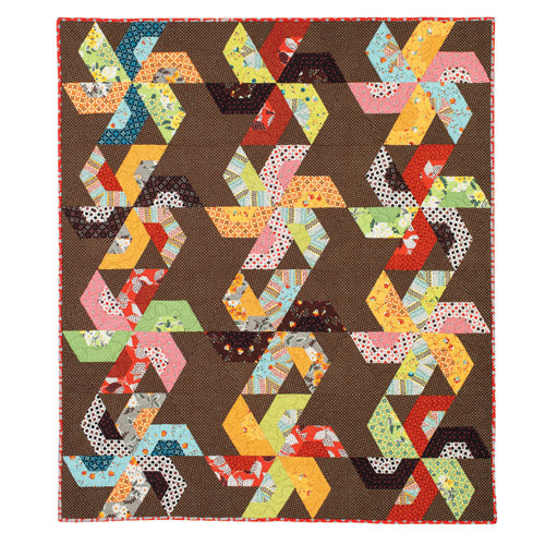 Flat shot of large pinwheel patchwork quilt