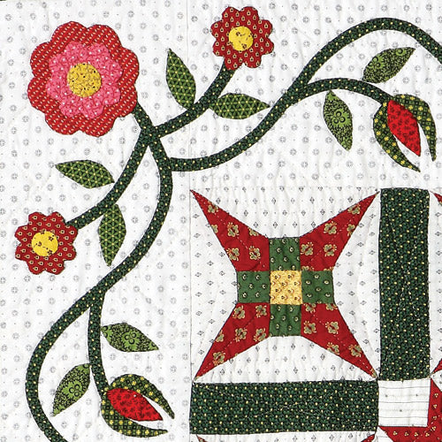 Closeup of patchwork star and appliqué flower and vine design