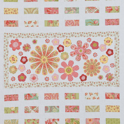 Closeup of appliqué flower centre and patchwork bricks from appliqué flower and patchwork quilt