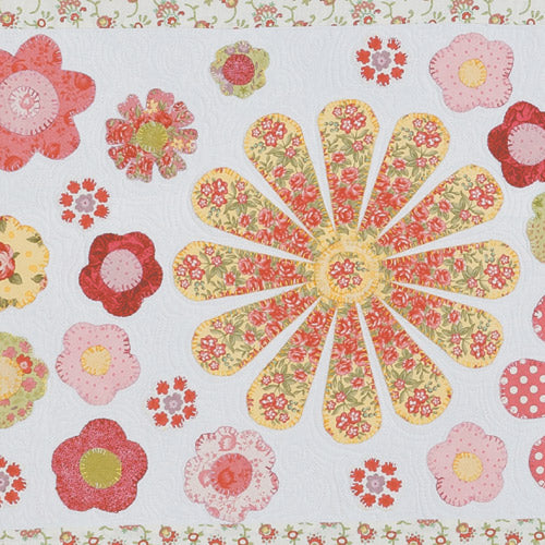 Closeup of appliqué flowers from appliqué flower and patchwork quilt