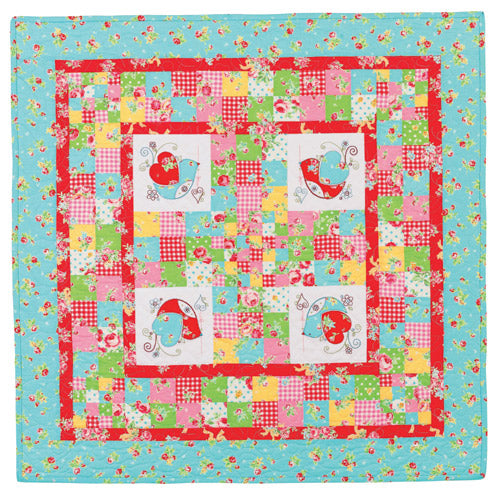 Flat shot of appliqué and embroidered bird patchwork quilt