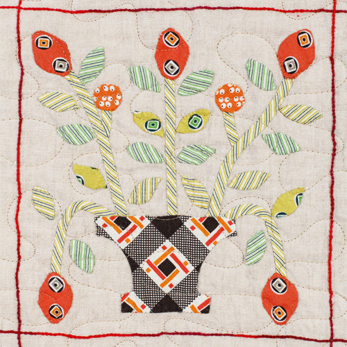 Closeup of appliqué flower in pot from vintage appliqué sampler quilt