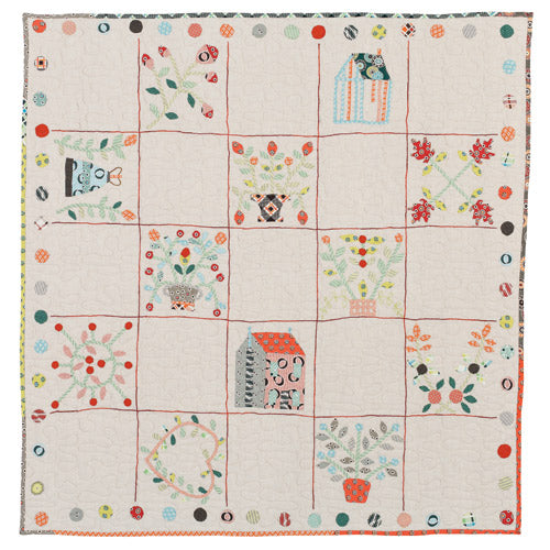 Flat shot of vintage appliqué sampler quilt