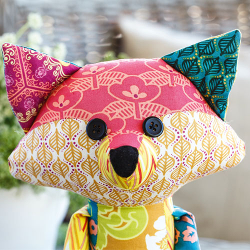 Closeup of bright patchwork fox soft toy's face