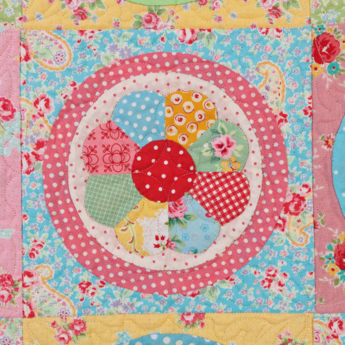 Closeup of dresden plate block from english paper pieced vintage dresden plate quilt