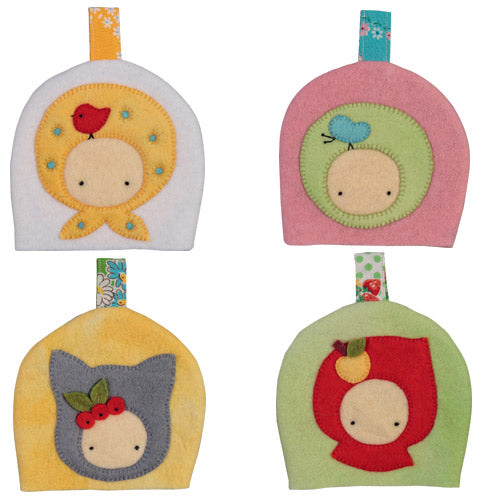 Flat shot of four different retro-style egg cosies