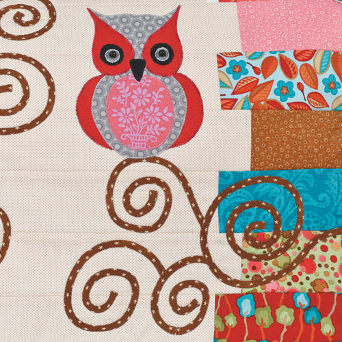 Closeup of appliqué owl and swirls from appliqué owl sewing machine cover