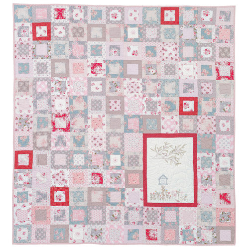 Flat shot of pretty embroidered patchwork quilt