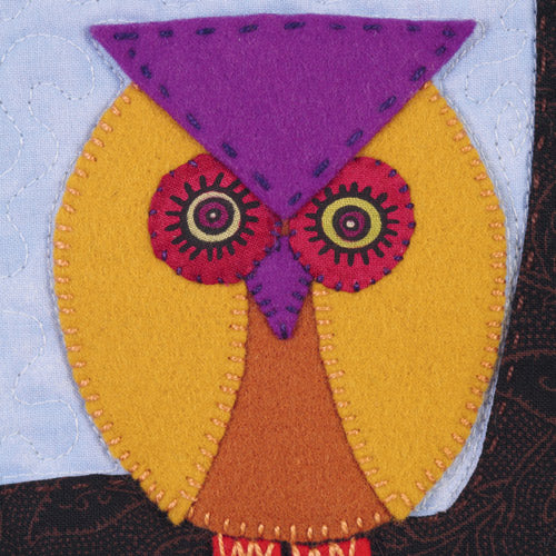 Closeup of appliqué owl from appliqué owl, bird, flower and tree quilt