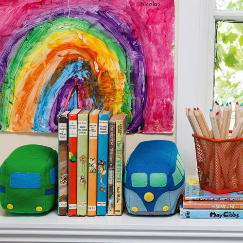 Styled shot of colourful campervan bookends with children's books