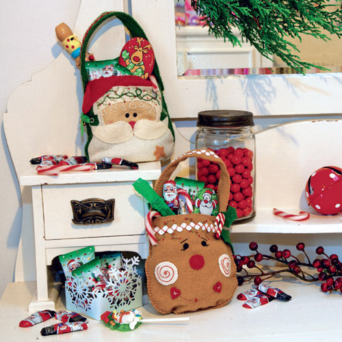 Styled shot of santa and rudolph christmas appliqué and embroidered bags with treats