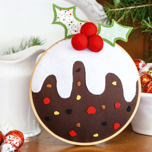 Styled shot of felt christmas pudding embroidery hoop art