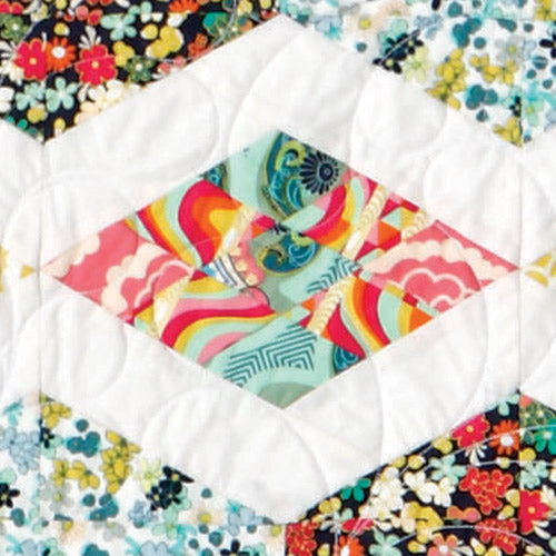 Closeup of strip pieced diamond block from diamond and hexagon patchwork quilt