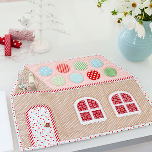 Styled shot of Christmas gingerbread house placemat with cutlery pocket on table
