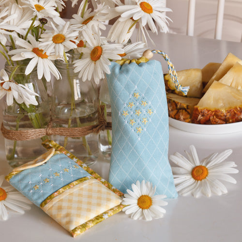 Styled shot of embroidered glasses and mobile phone pouches with flowers