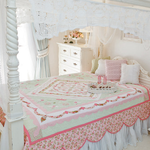Styled shot of traditional-style appliqué medallion quilt on bed