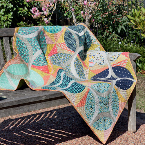 Styled shot of modern rings quilt over outside bench seat