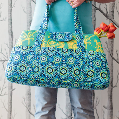 Styled shot of overnight bag with flowers
