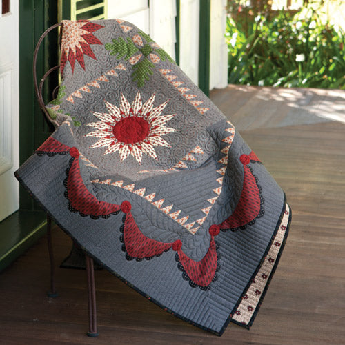 Styled shot of appliqué starburst quilt pattern on chair