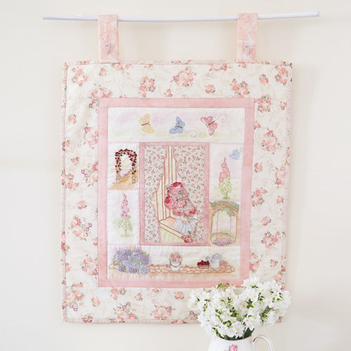 Styled shot of embroidered flower garden wallhanging
