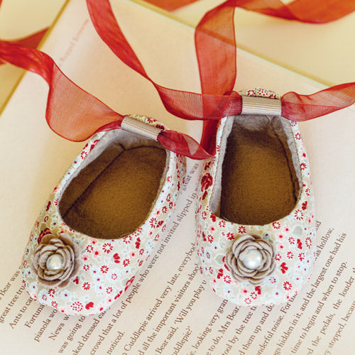 Styled shot of baby ballet-style slippers