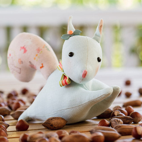 Styled shot of pastel squirrel softie with nuts