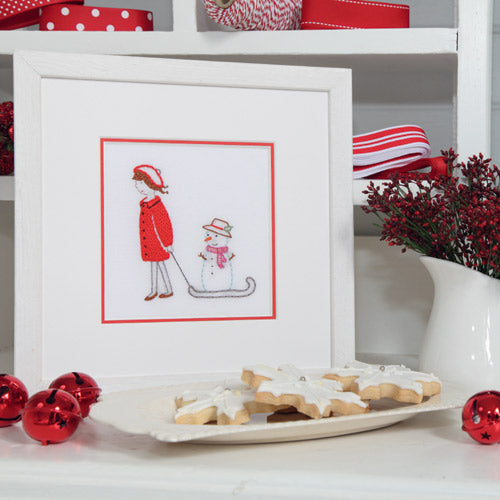 Styled shot of Christmas winter snow embroidery with Christmas cookies and ornaments